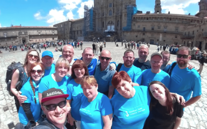 Charity group posing in front of the Cathedral in Santiago