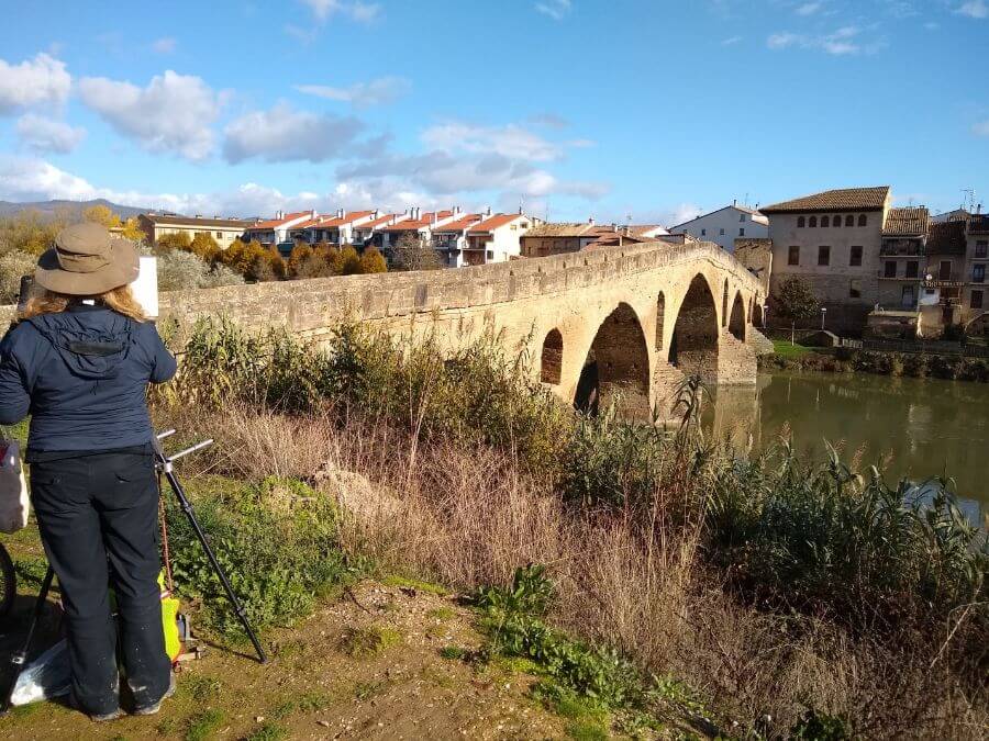 Sharon painting the Way of St James in December on a chilly but beautifully sunny day. Painting Puente la Reina, number 103 