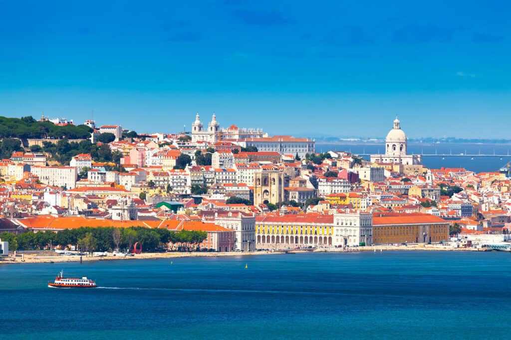 A panoramic view of Lisbon, with the the Praça do Comércio in the foreground. You can explore Lisbon as a Day Tour from the Camino.